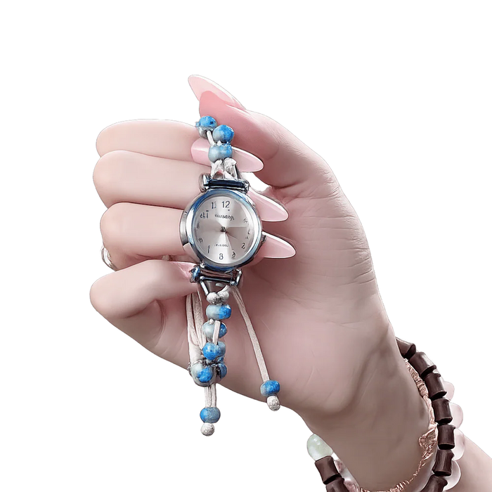 Hand holding a blue beaded fashion watch