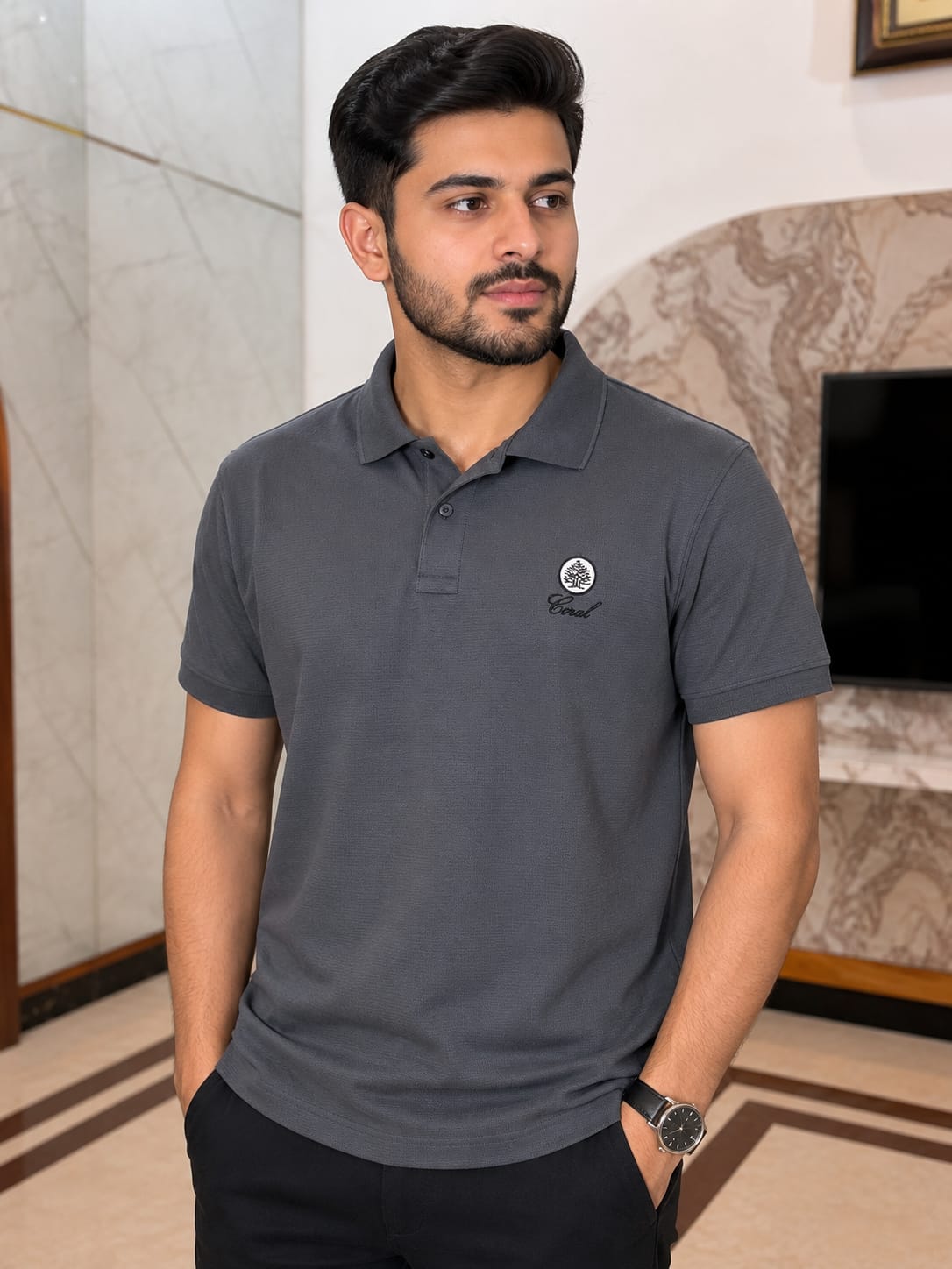 Men wearing a charcoal grey textured short sleeve polo shirt